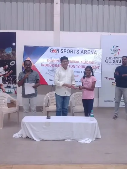 A young girl is awarded her prize. Our events provide a competitive platform for both boys and girls.