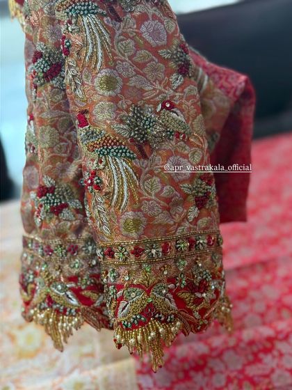 A brocade blouse with stunning peacock embroidery on the sleeves.