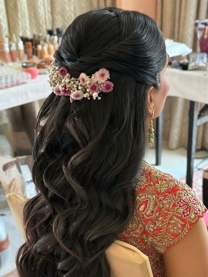 A close-up of the floral half-up style, showing the detail of the twist and the fresh flowers.