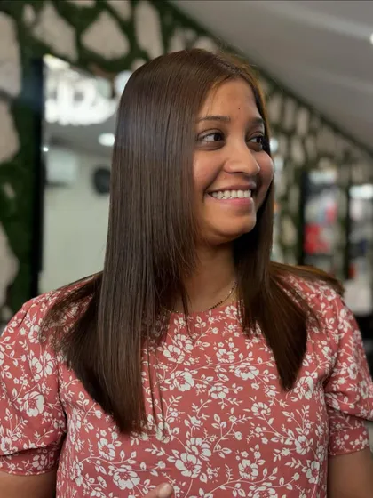 Another happy client showing off her silky smooth hair. Our treatments are designed to give you the hair of your dreams, full of shine and free of frizz.