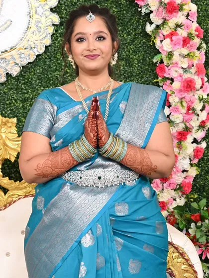 Jebha's engagement look, with her welcoming guests with a traditional namaste. Her makeup is fresh and radiant.