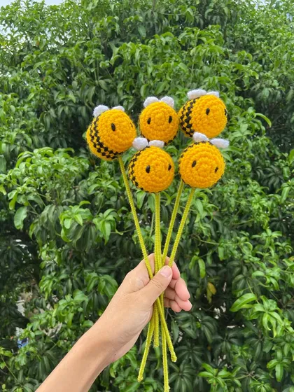 A handful of amigurumi bee stems, a fun and whimsical addition to any floral arrangement.