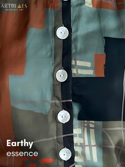 A close-up of the Earthlines top, highlighting the mother-of-pearl buttons and the rich, painterly print. It’s a look for days when calm becomes your statement.
