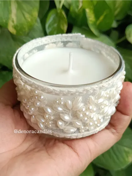 Another hand-held view of the white lace jar candle.