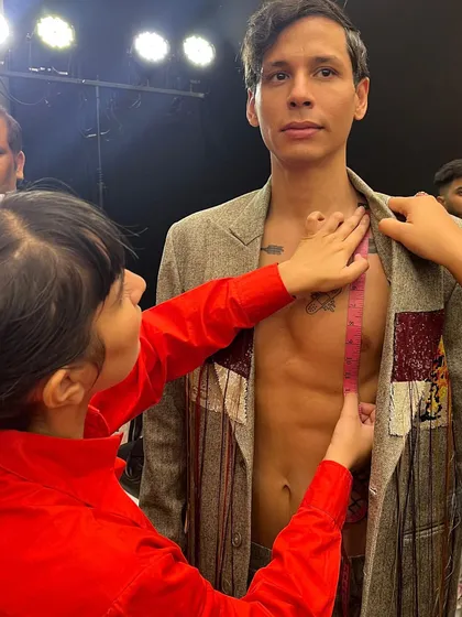 The precision of backstage. Here, I'm taking measurements to ensure the perfect fit for a model's runway look at the Huemn show.