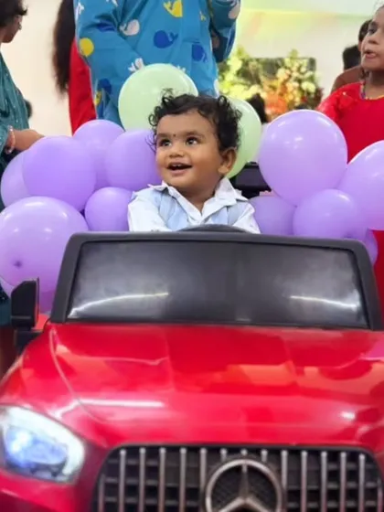Nothing beats the pure joy on a child's face. This is a close-up of our popular 'Baby Royal Entry', where the little star of the show gets to drive in, surrounded by balloons and beaming with happiness. It's a picture perfect moment parents cherish.