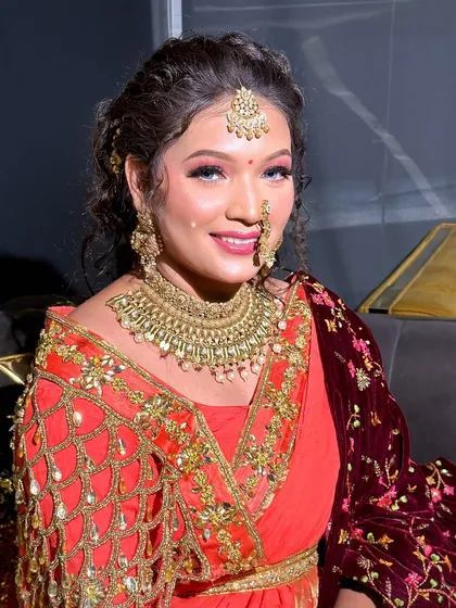 A smiling portrait of the bride, looking confident and beautiful in her bright makeup.