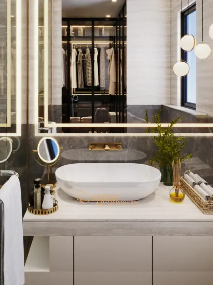 A close-up of the vanity, highlighting the vessel sink, gold accents, and the layered lighting from both the mirror and pendant fixtures.