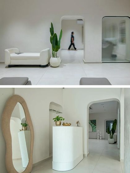 The interior uses arched doorways and curved furniture to create a soft, flowing space that feels both modern and welcoming.