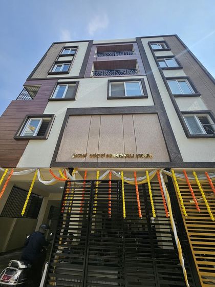 A close-up of the entrance to the Srirampura project, where you can see the detail in the gate design and the nameplate integrated into the building's facade.