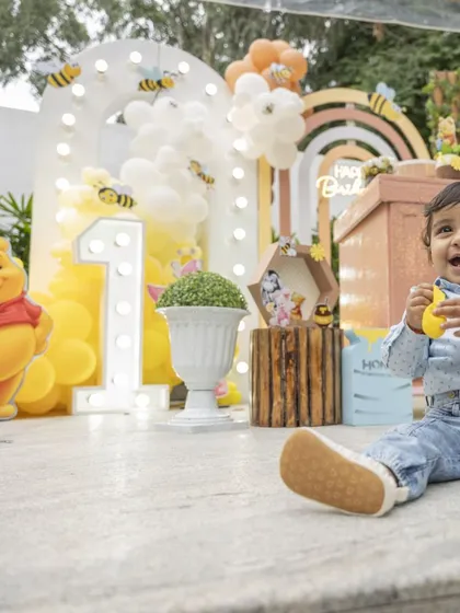 Nothing makes me happier than seeing the birthday child enjoy the world I've built for them. This sweet moment from a Winnie the Pooh party, with the birthday boy sitting right in front of the decor, is why I pour my heart into every detail.