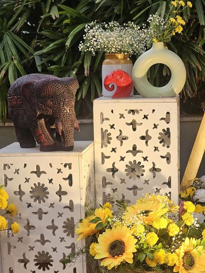 I believe every detail matters. For this traditional event, I used decorative pedestals with elephant statues and flower vases to enhance the overall aesthetic.