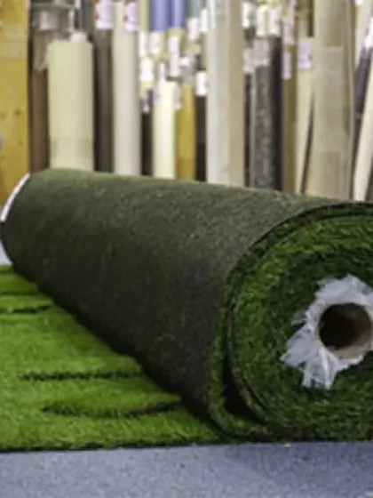 This is a view of my warehouse stock, showing a large roll of turf ready for a project. As a wholesaler, I keep a wide variety of artificial grass rolls on hand for quick supply and installation.