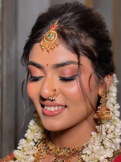 A close-up of the eye makeup and traditional nath, part of a beautiful South Indian bridal look.