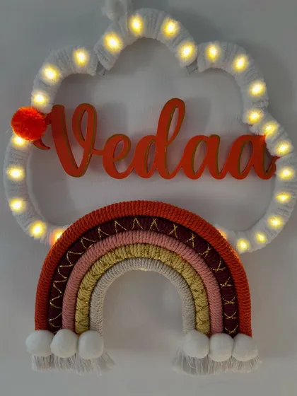 The 'Vedaa' name hanging lit up, creating a magical and warm ambiance perfect for a child's bedroom.