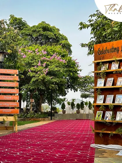 A personalized welcome area with a wooden sign detailing the wedding events and a 'Celebrating Love' photo wall, allowing guests to feel connected to the couple's story.