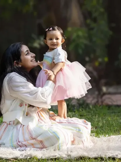 Lifting her up to see the world. This playful interaction between mother and daughter is a perfect example of the sweet, candid moments we capture.