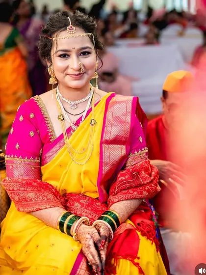 A candid moment from the wedding ceremony. The bride looks serene and beautiful with her subtle makeup and traditional attire.