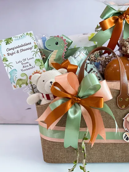 A personalized card adds a warm, finishing touch to this jungle-themed jute bag hamper, making it a thoughtful and complete gift.