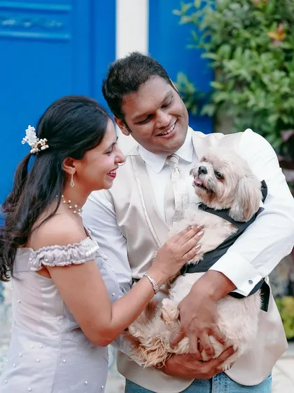 A sweet family portrait. Capturing the love between a couple and their pet is always a joy, and it adds such a personal and warm touch to your photo gallery.
