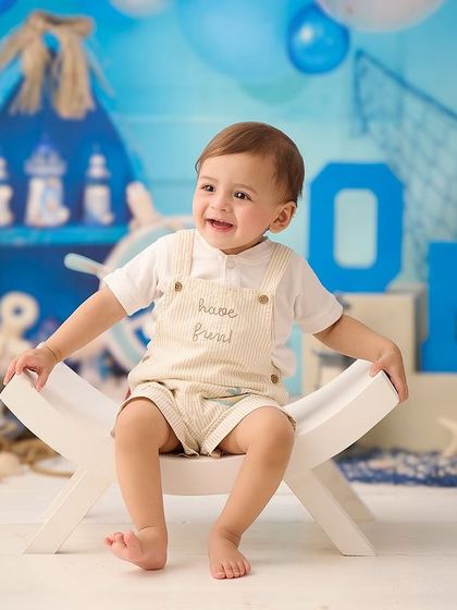 A nautical-themed first birthday shoot is perfect for a little sailor. We use themed props and a blue color palette to bring the seaside to our studio.