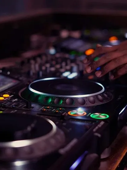 A detailed look at my hand adjusting levels on the console. Mastering the mixer is a core part of my DJ training for beginners and experienced artists alike.