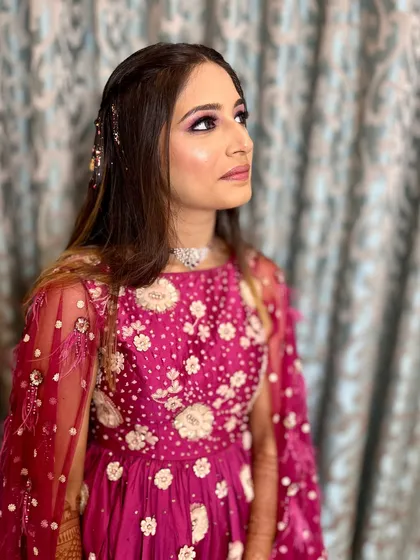 A dreamy, glamorous look for the sangeet. The purple eyeshadow makes her eyes pop.