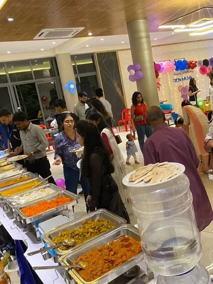 A vibrant buffet setup for a birthday party, with guests enjoying a wide selection of our vegetarian dishes. This shows our capability to cater for lively, modern celebrations with a diverse menu.