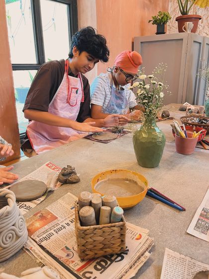 This is a typical scene from one of our kids' birthday parties. Everyone is working on their own hand-building project, from coil pots to little sculptures.