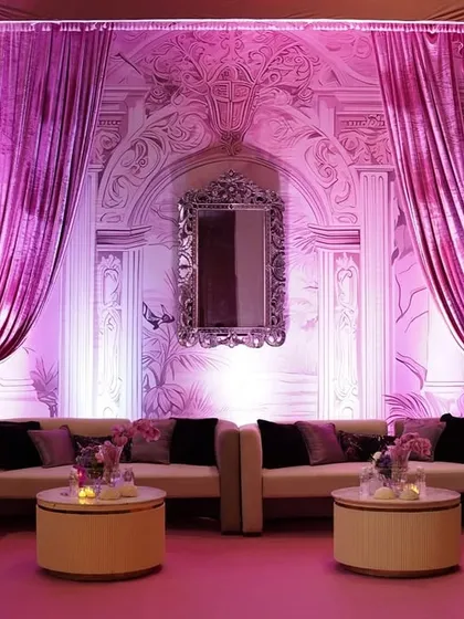 Another angle of the pink lounge, showcasing the dramatic drapes and the sophisticated arrangement of seating designed for conversation and comfort.