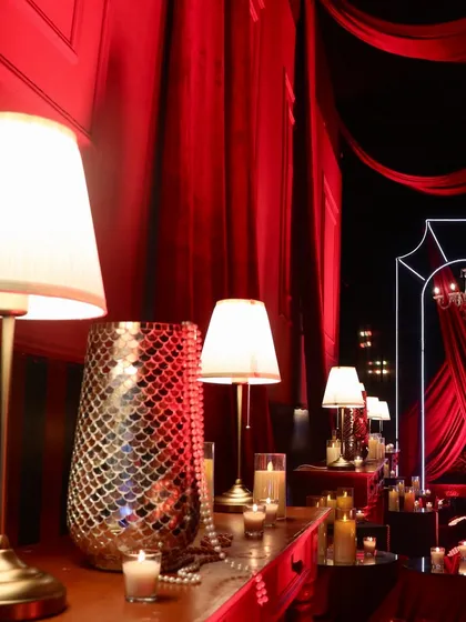 Every corner was a photo opportunity. This detailed view shows our use of table lamps, pearl strings, and mosaic vases to add layers of texture and warmth to the opulent red decor.