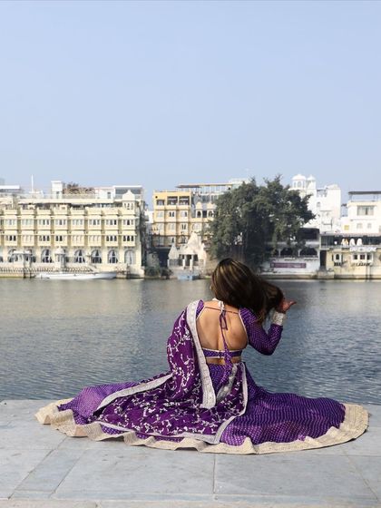 The back view of our purple bandhani-style lehenga, showing off the stylish backless design. It's a perfect choice for a scenic pre-wedding photoshoot.