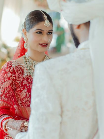 An intimate moment captured between the couple. The bride's soft glam makeup, with a focus on her eyes, looks beautiful and romantic.