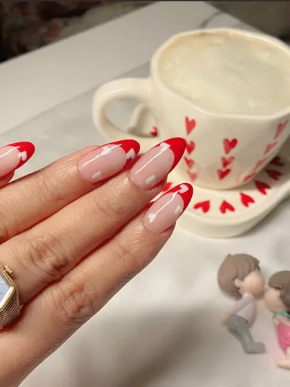 Another angle of the romantic red heart French manicure, paired with a cute, heart-themed coffee cup. It's all in the details.