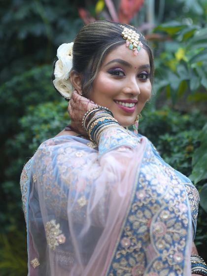 A beautiful outdoor shot from a student's portfolio. The natural light highlights the flawless makeup application.