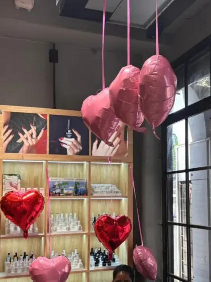 The decorations are designed to enhance, not obstruct. Here, the hanging balloons frame the view of the salon's product displays and service areas, adding to the ambiance without getting in the way.