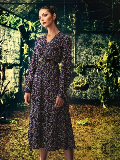 A lush, overgrown ruin, created with projection. The setting provides a mysterious and romantic backdrop, blending nature and history for a unique fashion shot.