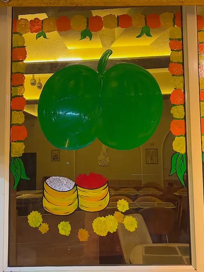 This glass painting for Dussehra features symbols of the festival, including the 'Apta' leaves, which are traditionally exchanged as gold.