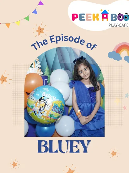 The birthday girl looking picture-perfect at her "Bluey" themed celebration, surrounded by character balloons and festive decor.