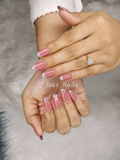 A stylish look with a dusty rose base and sparkling silver French tips.