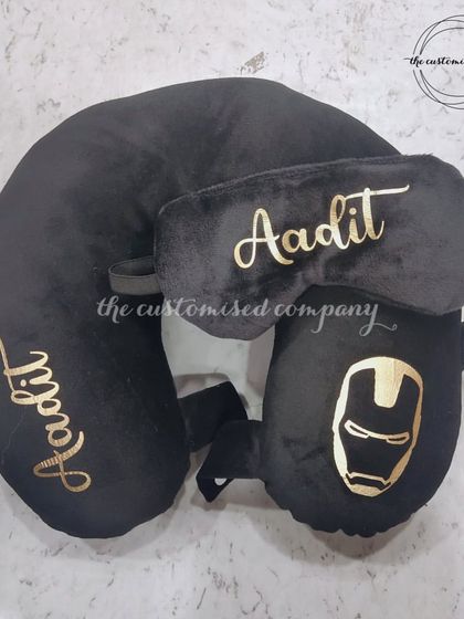 Travel in superhero style with this Iron Man-themed travel set. The all-black collection includes a personalized neck pillow, eye mask, and a foldable travel pillow for ultimate comfort.