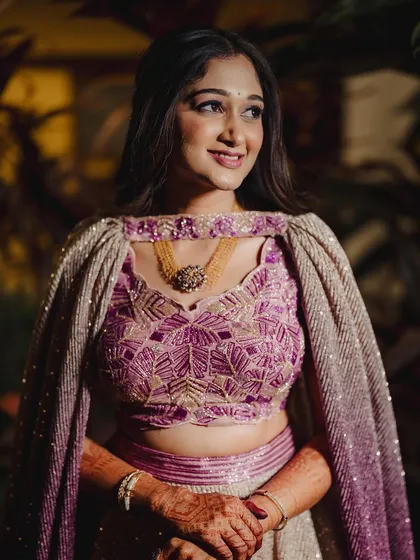 This image captures the beautiful details of her sangeeth lehenga and the soft, glowing makeup.