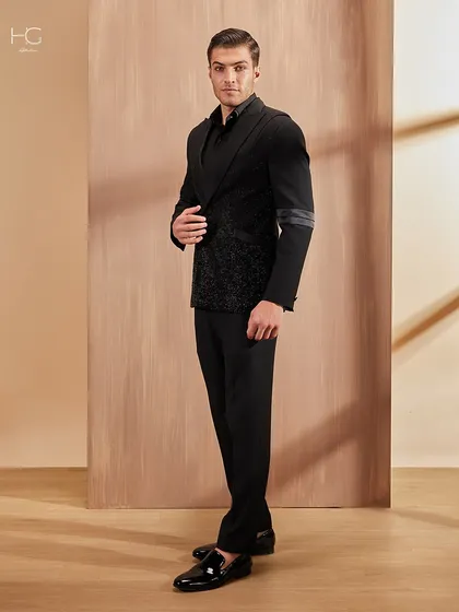 Another angle of the statement cocktail jacket, demonstrating its sleek fit and the way the different textures play with the light.