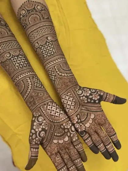 A classic full-hand design with a mix of geometric and traditional patterns.