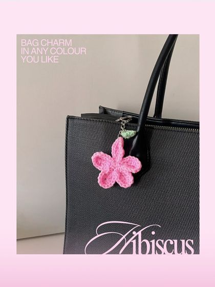 Here is my pink hibiscus flower charm attached to a black tote bag to show how it can be styled. You can order this bag charm in any color to match your favorite accessories.