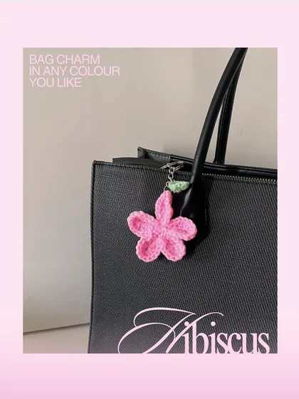 Here’s how the pink hibiscus charm looks on a classic black tote bag. I can make these in any color to match your personal style or your favorite bag.