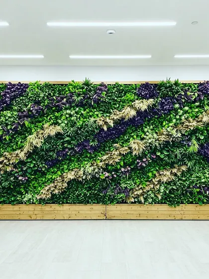 A large-scale vertical garden with a dynamic, diagonal design. We used bands of different colored and textured plants to create a sense of movement and energy across the wall.