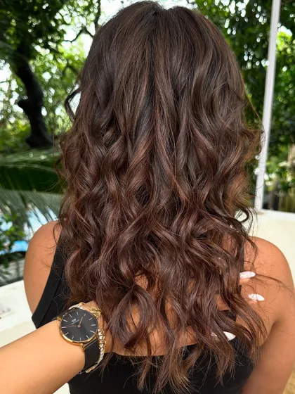 Holiday ready with these soft, beachy waves and subtle brunette highlights. This is a low-maintenance color that grows out beautifully, perfect for someone who travels a lot.