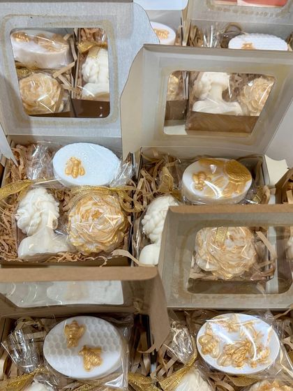 A look inside my custom gift boxes. This one features a 'Lady' bust candle, a peony candle, and other small soap favors, all in a white and gold theme.