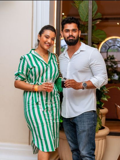 A couple enjoys a drink together, perfectly dressed for a stylish Sunday at Roxie.